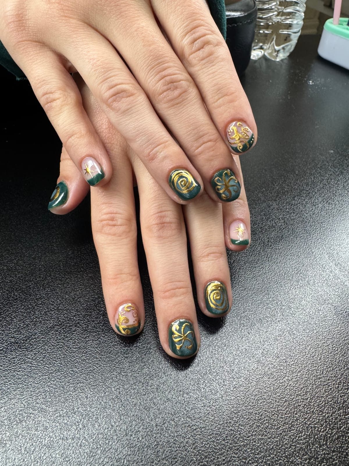 Green and gold hand-painted manicure by Shifa Nail Care