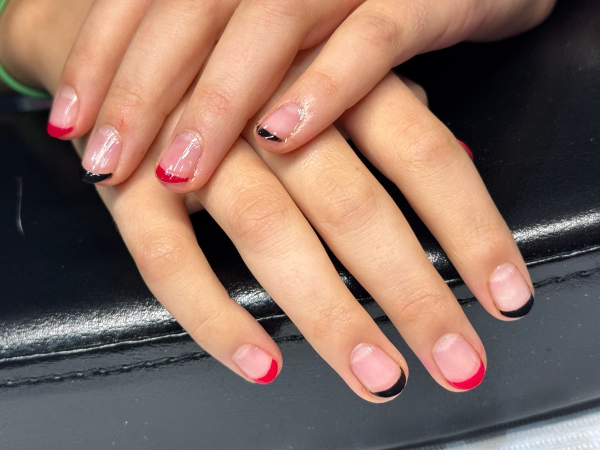 Red and black French tip manicure by Shifa Nail Care